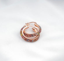 Load image into Gallery viewer, Rose gold hoop earrings with colorful gemstones on a light gray background