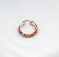 Rose gold hoop earring with multicolored stones on a light gray background